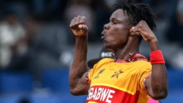 Richard Muzarabani bowling during T20 World Cup match under stadium lights