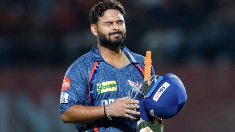 Rishabh Pant walking off the field holding his bat with grimace